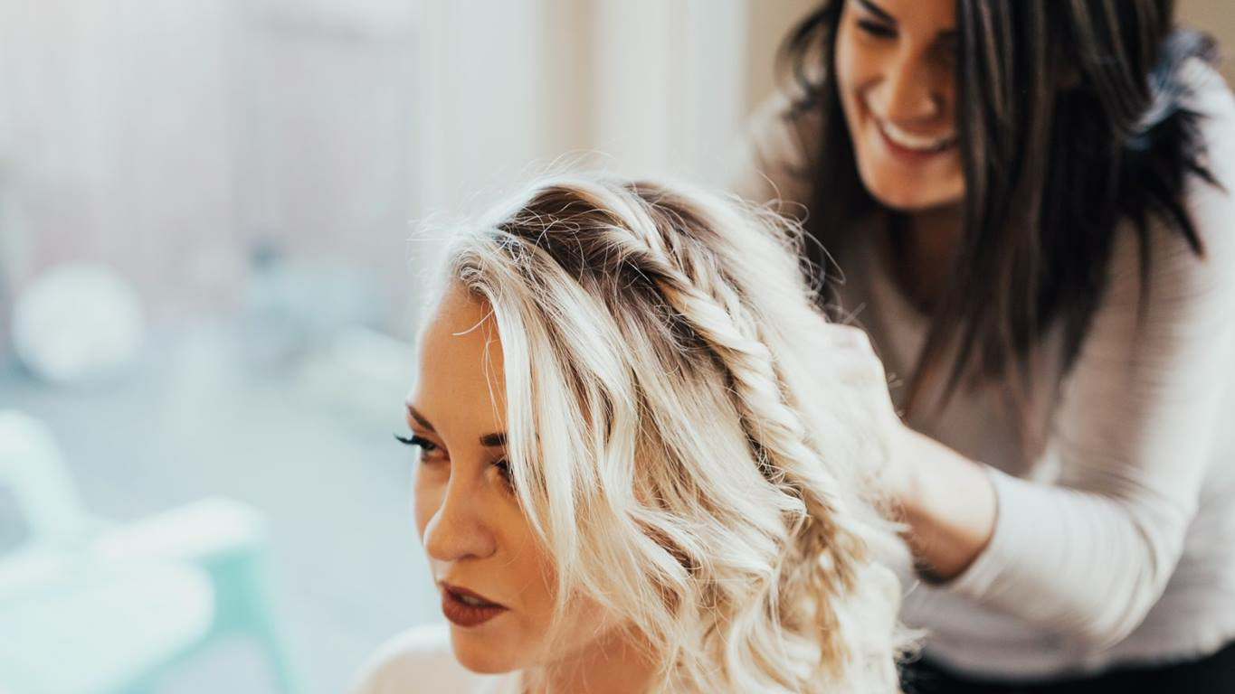 Michaela styling a client's hair